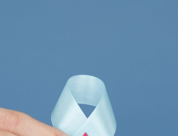 person holding a white diabetes awareness ribbon with decorated blood drop