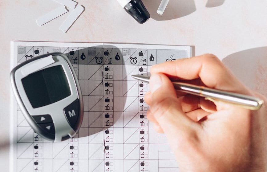 a person recording his blood sugar reading