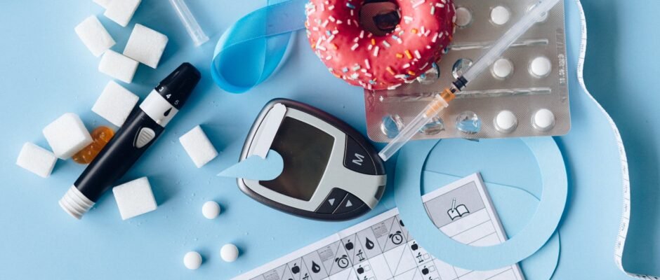 blood sugar meter and medication on the blue background