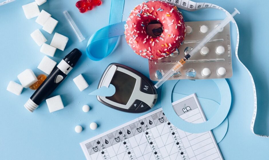 blood sugar meter and medication on the blue background